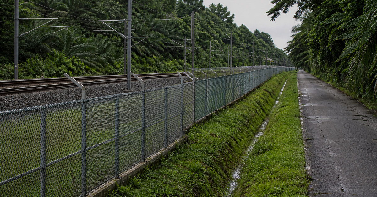 Serendah 一段有围栏的铁路走廊与工业服务道路分隔